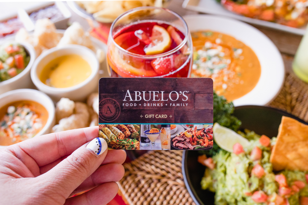 Hand holding Abuelo's gift card